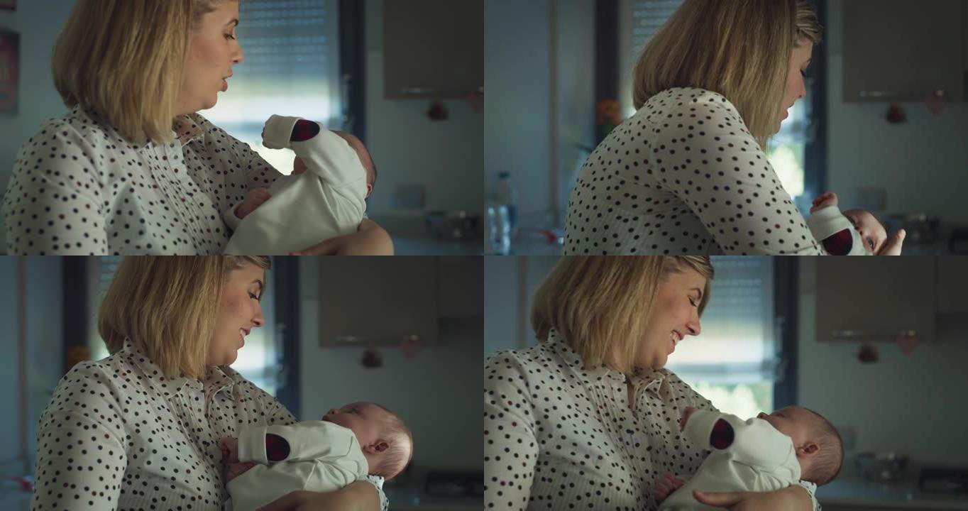 一位年轻的neo母亲的电影镜头正在怀抱中，并在早晨在厨房里爱抚她的新生婴儿。母性，母性，父母身份，童