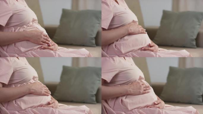 孕妇抚摸腹部