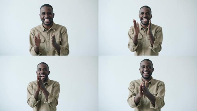 快乐的非洲裔美国男子拍手疯狂表情的慢动作肖像