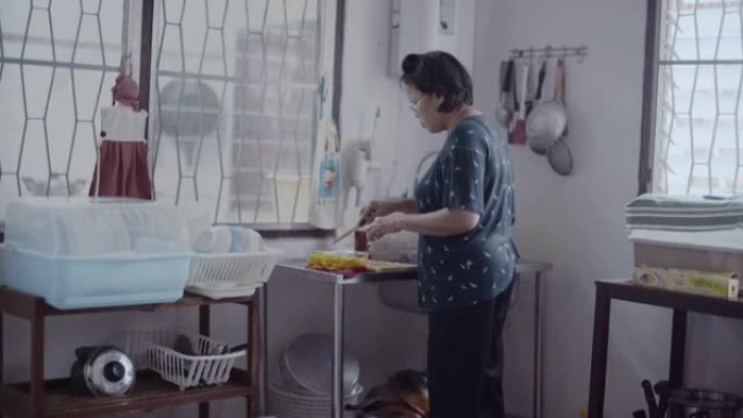 一名妇女准备将柠檬片与厨房中的蜂蜜混合
