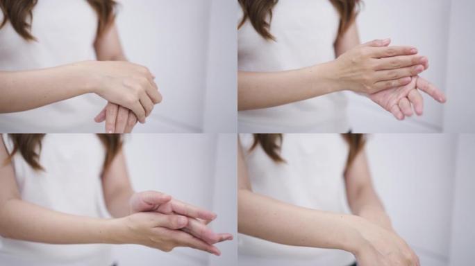 Woman using moisturizer cream on her hands