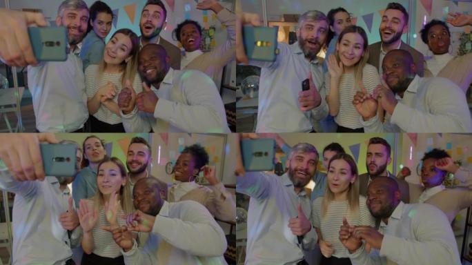 快乐的商业团队在愉快的派对中为智能手机相机拍照和跳舞拍照