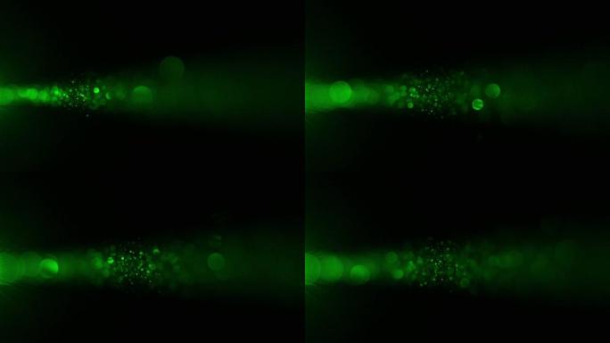 绿色激光光线照在黑色背景上。慢动作