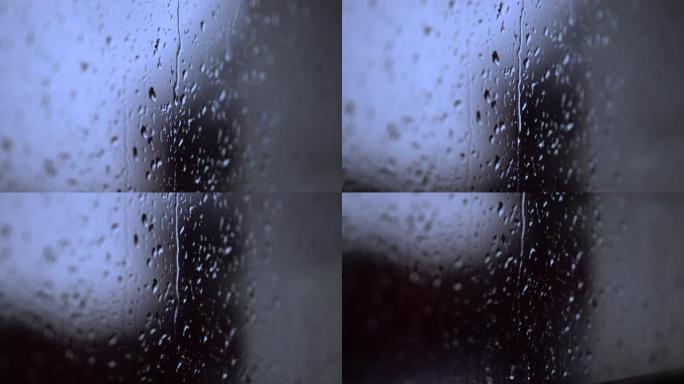 窗户上的雨雨顺着窗户滑下雨天