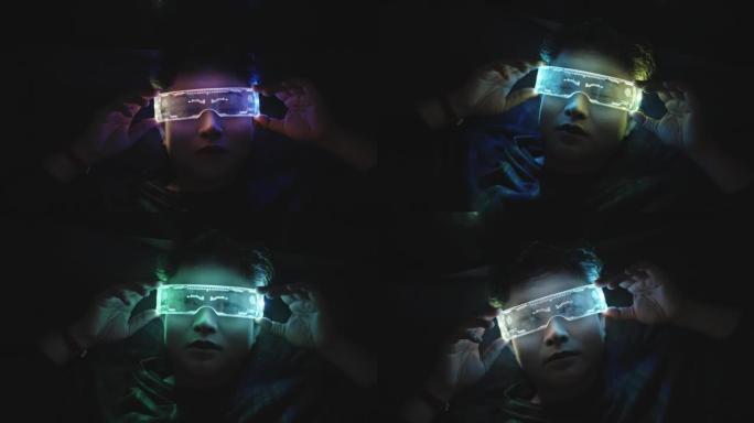使用虚拟现实眼镜的亚洲女性晚上躺在床上，紫外线赛博朋克眼镜