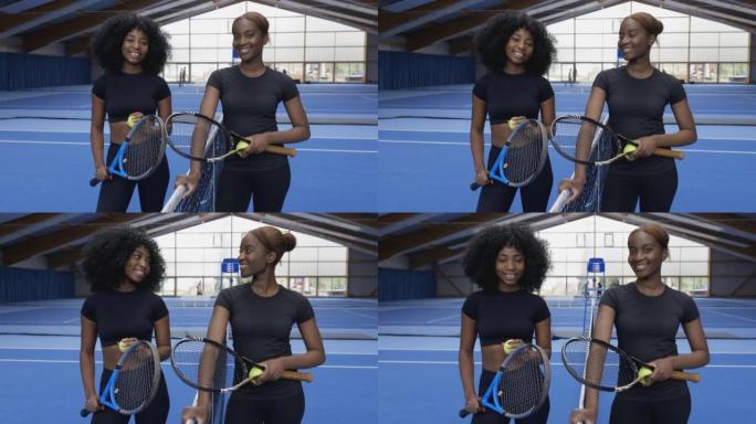 两名年轻的非洲女子网球运动员在硬地球场上的肖像