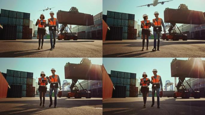 带平板电脑的女工业工程师和戴着安全帽的男工头工人在集装箱码头行走。VFX飞机在天空中飞行，双梁龙门起