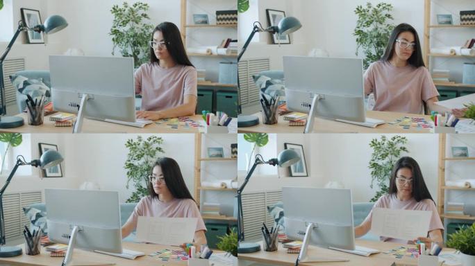 年轻的亚洲女性应用设计师使用pc并在家中室内观看智能手机屏幕图片