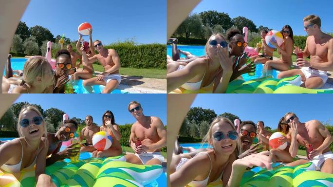 穿着泳装的年轻多民族朋友的真实照片是在五颜六色的充气设备上放松，并在阳光明媚的日子里用智能手机在游泳