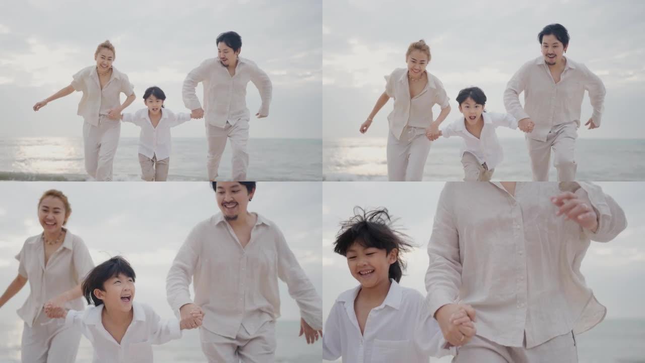 亚洲家庭牵着手在日落时沿着海滩奔跑