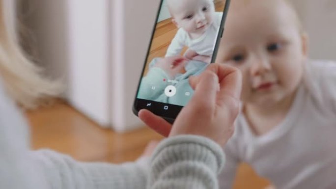 母亲用智能手机给婴儿拍照，享受在社交媒体上分享母亲生活方式的可爱幼儿拍照