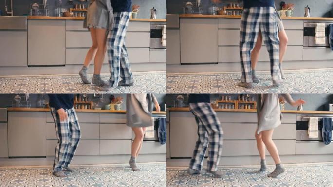 4k视频片段，一对无法识别的夫妇在家里的厨房里跳舞