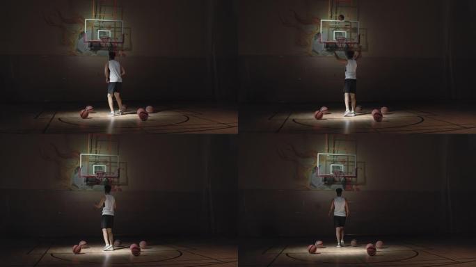 运动员在黑暗的室内球场上射击篮球