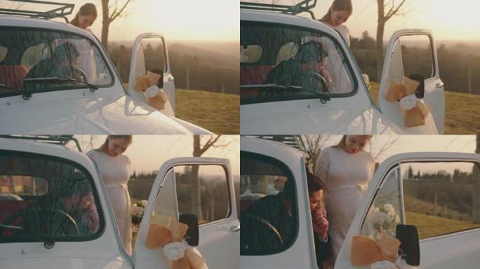 新婚新郎坐在车里亲吻他美丽的新娘的手