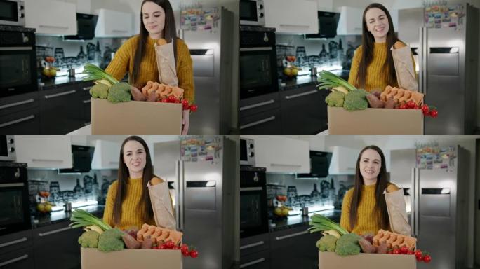慢动作快乐的年轻女子把食品盒放在柜台上，对着镜头说话