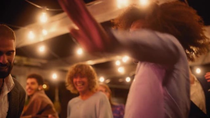 美丽的无忧无虑的朋友们的特写镜头正在一起跳舞，并在聚会上庆祝晚间活动。多元化的多民族年轻人在餐厅的公