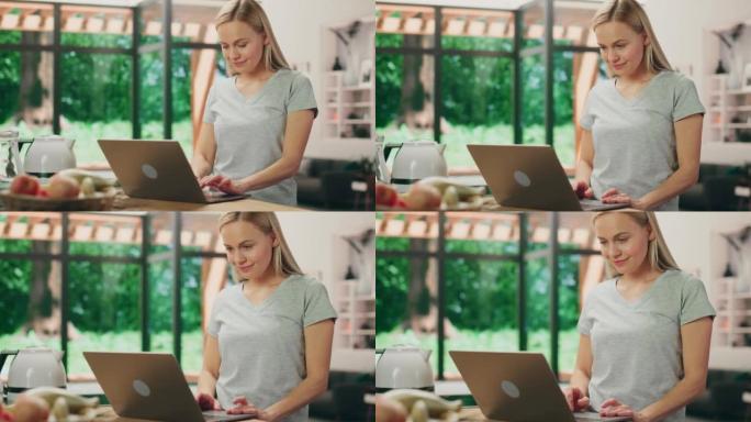 美丽的年轻成年女性肖像，金发碧眼，穿着灰色v领t恤，站在客厅时使用笔记本电脑。在光明之家在家工作的成