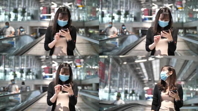 在机场使用智能手机戴口罩的女人