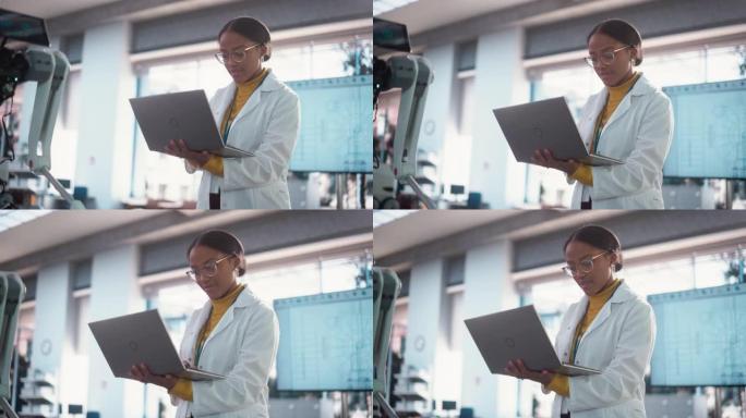 穿着实验室外套的年轻黑人女性专家的肖像微笑着使用笔记本电脑。专业而成功的女性担任工程师，开发高科技项