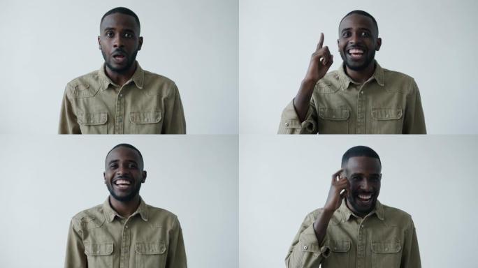 快乐的非裔美国人的肖像举起手指有好主意然后笑