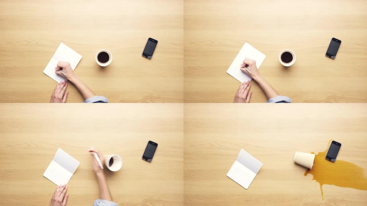 4k视频片段，一个无法识别的女人独自坐在工作室里，一边做笔记一边洒咖啡