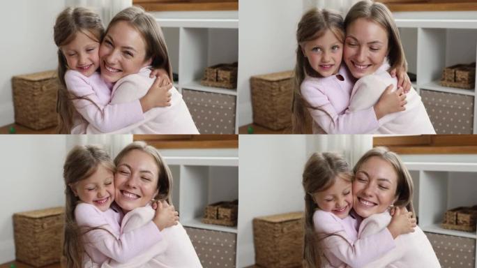 可爱的年轻妈妈拥抱她可爱的学龄前5s女儿，特写