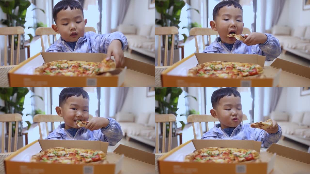 吃披萨的亚洲男孩吃披萨的亚洲男孩美食