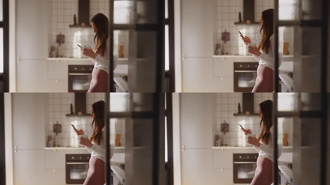 女人在厨房里使用智能手机