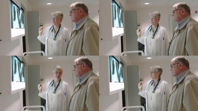 女放射科医生与医院的高级男子讨论x射线检查结果