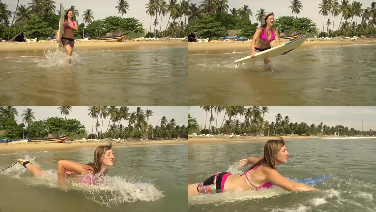女冲浪者跑到水里开始划水