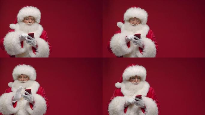 一个开朗的圣诞老人正在热情地在网上购物，在红色智能手机上选择一些东西，站在红色背景下，有一个链接的地