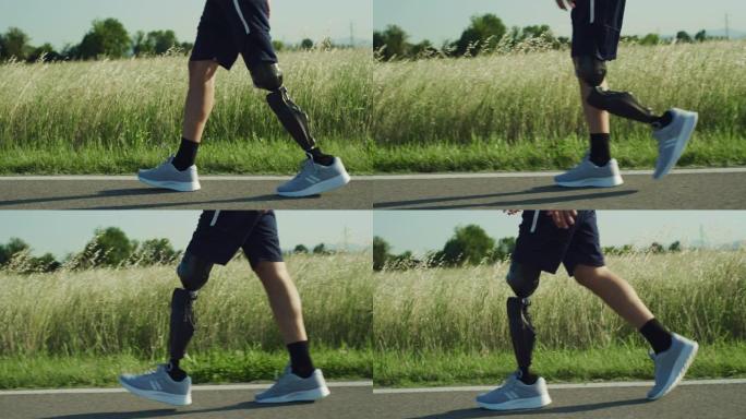 残疾运动员在路上行走的侧视图。一个拥有现代仿生假肢的人训练后平静地漫步。关闭技术先进的人造腿。