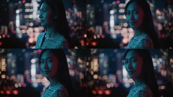 美丽的亚洲女性肖像深夜站在霓虹灯下的城市街道上。地道的成年自信女人在镜头前摆姿势，在市中心商业街的夜