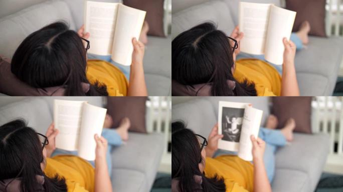 女人在家放松时在沙发上看书