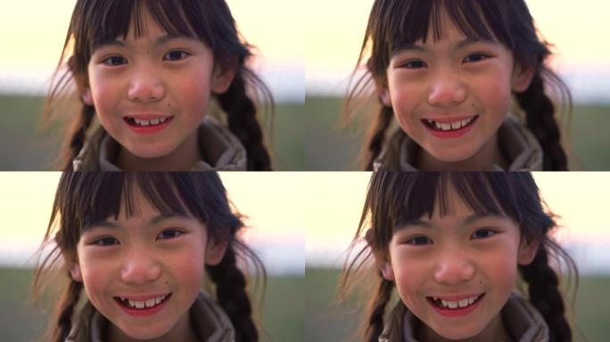 亚洲女童，面带微笑的脸和公园，夏天的特写镜头和玩耍，自由户外和幸福。快乐的孩子，年轻的女性，在日本度