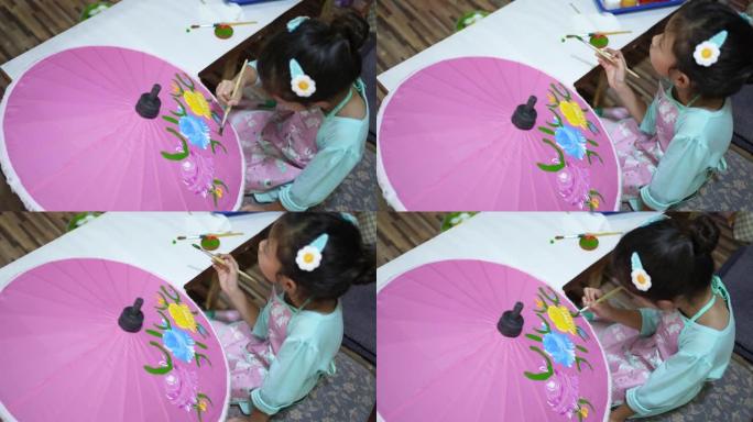 女孩在雨伞上画艺术品