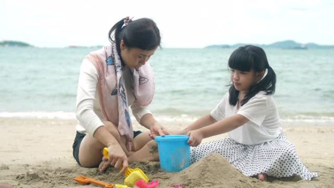 家人在沙滩上玩耍海浪玩沙子堆沙堡铲子小桶