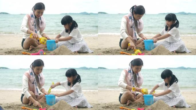 家人在沙滩上玩耍海浪玩沙子堆沙堡铲子小桶