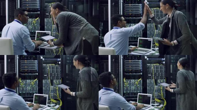 两名技术人员在服务器机房一起工作时互相击掌的4k视频片段