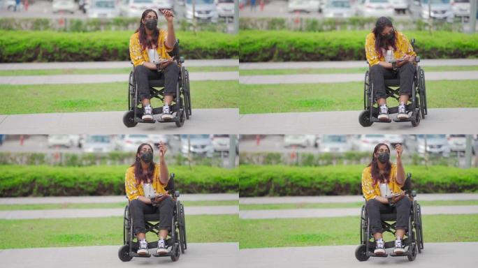 亚洲印度残疾女性坐轮椅在城市街道的垫子上素描