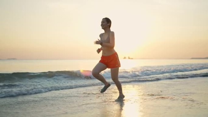 慢动作运动女子在沙滩上跑步