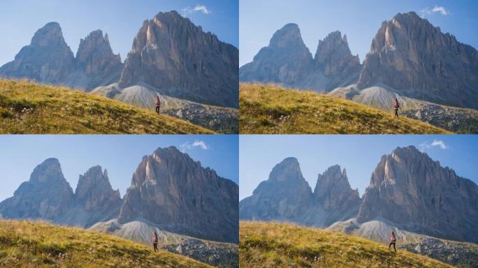 女徒步旅行者在风景令人难以置信的群山中上山行走