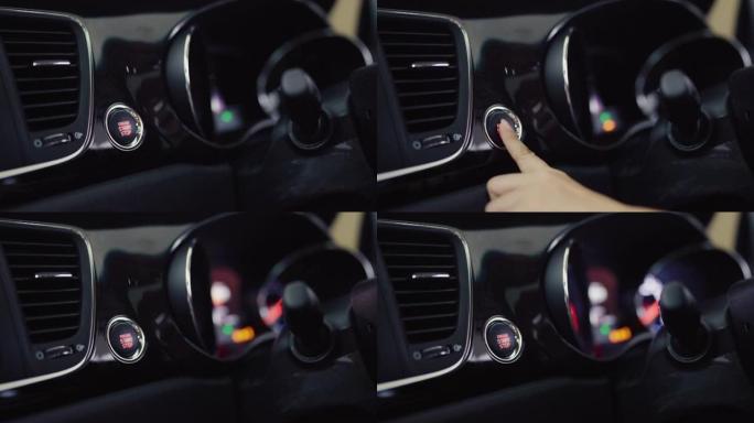 女性手推启动汽车发动机按钮。