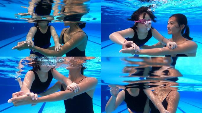 亚裔华裔少女与教练在水中练习呼吸练习