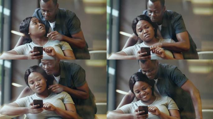 幸福的非洲夫妻一起用手机
