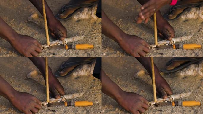 特写裁剪视图哈扎狩猎采集者部落成员用传统的方式制造坦桑尼亚的火