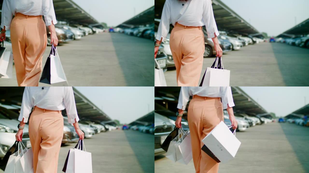 女人拿着购物袋走路
