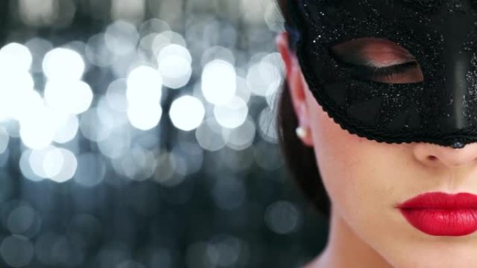 4k视频片段，一名在工作室背景下戴着面具的性感年轻女子