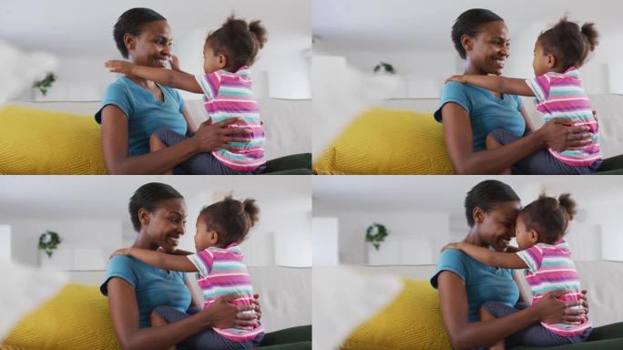快乐的非洲裔美国母女坐在沙发上摸额头