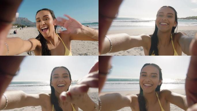 年轻的混血女子在海滩上视频聊天女孩在相机上吹吻分享暑假使用智能手机展示旅游冒险度假乐趣